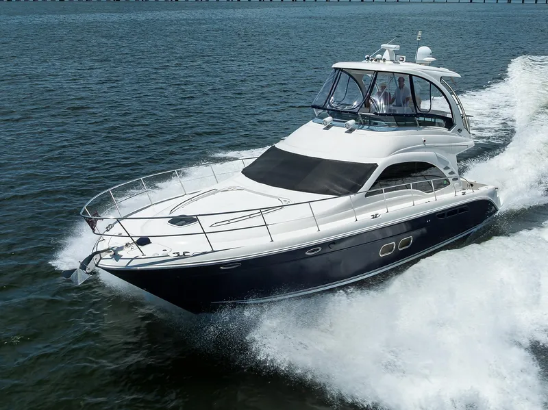 Slide: The Image of 2005 Sea Ray 52 Sedan Bridge yacht cruising on open water. - 45