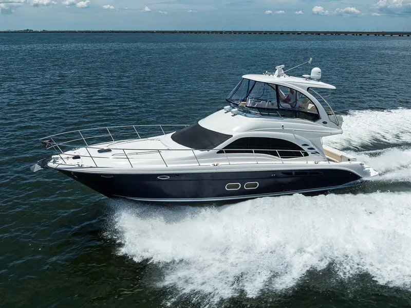 Slide: The Image of 2005 Sea Ray 52 Sedan Bridge yacht cruising on open water. - 46