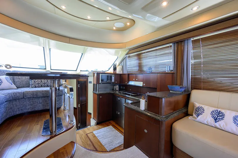 Slide: The Image of Luxurious interior of 2005 Sea Ray 52 Sedan Bridge yacht with modern kitchen and seating area. - 5