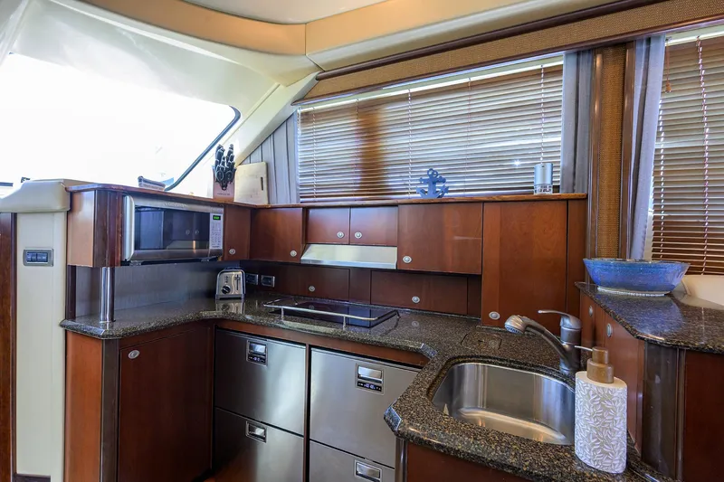 Slide: The Image of Luxurious kitchen interior of 2005 Sea Ray 52 Sedan Bridge yacht with modern appliances. - 6