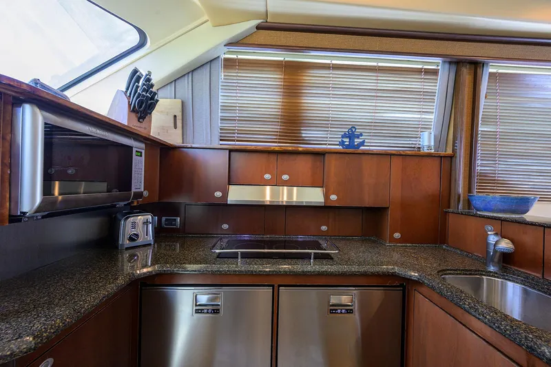Slide: The Image of Luxurious kitchen interior of 2005 Sea Ray 52 Sedan Bridge yacht with modern appliances. - 7
