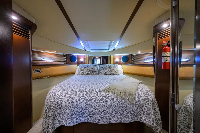 Slide: The Image of Luxurious 2005 Sea Ray 52 Sedan Bridge bedroom with elegant bedding and ambient lighting. - 8