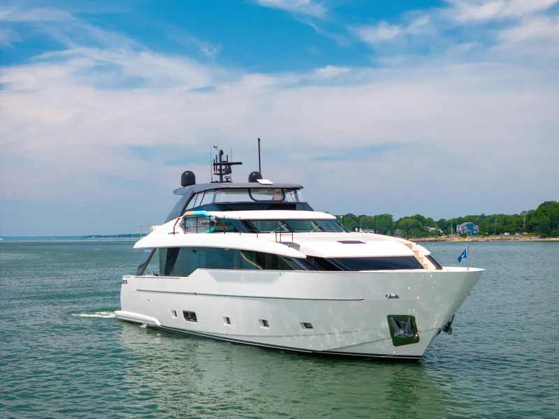 Slide: The Image of 2024 Sanlorenzo SL90A yacht cruising on a serene waterway under a clear blue sky. - 11