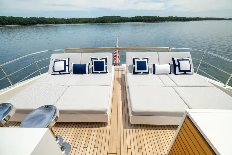 Slide: The Image of Luxurious 2024 Sanlorenzo SL90A yacht deck with elegant sun loungers and scenic water view. - 23