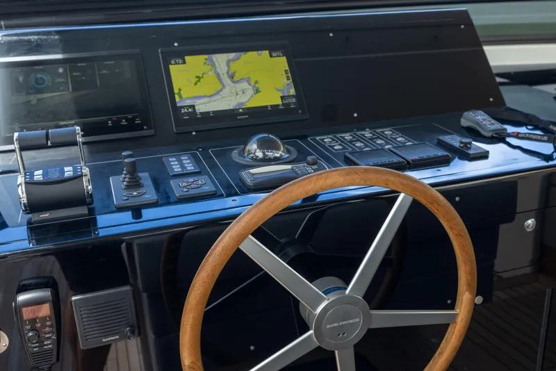 Slide: The Image of 2024 Sanlorenzo SL90A yacht helm with navigation controls and wooden steering wheel. - 31
