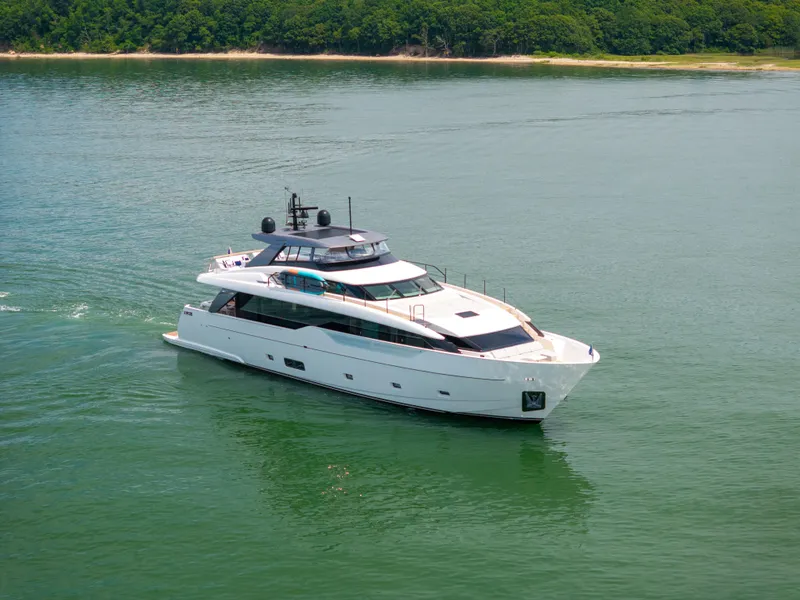 Slide: The Image of 2024 Sanlorenzo SL90A yacht cruising on calm waters near a lush shoreline. - 4