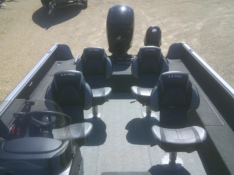 Slide: The Image of 2020 Lund 1875 Impact SS boat interior with four seats and motor. - 13