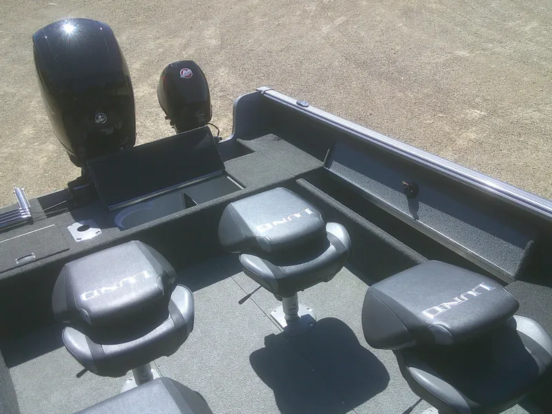 Slide: The Image of 2020 Lund 1875 Impact SS boat interior with seating and motor, viewed from above. - 14