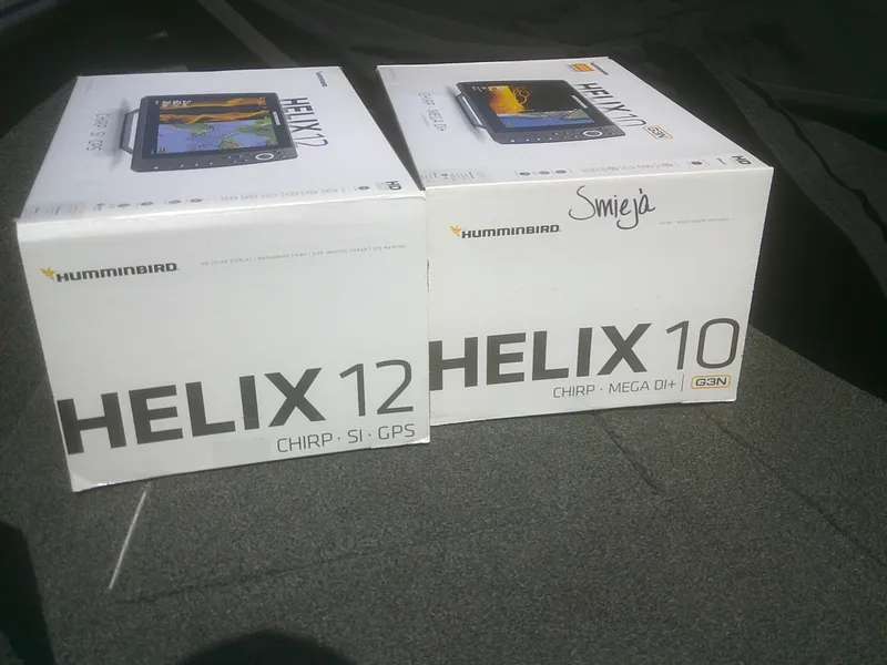 Slide: The Image of Boxes of Humminbird Helix 12 and Helix 10 fish finders on a 2020 Lund 1875 Impact SS. - 17