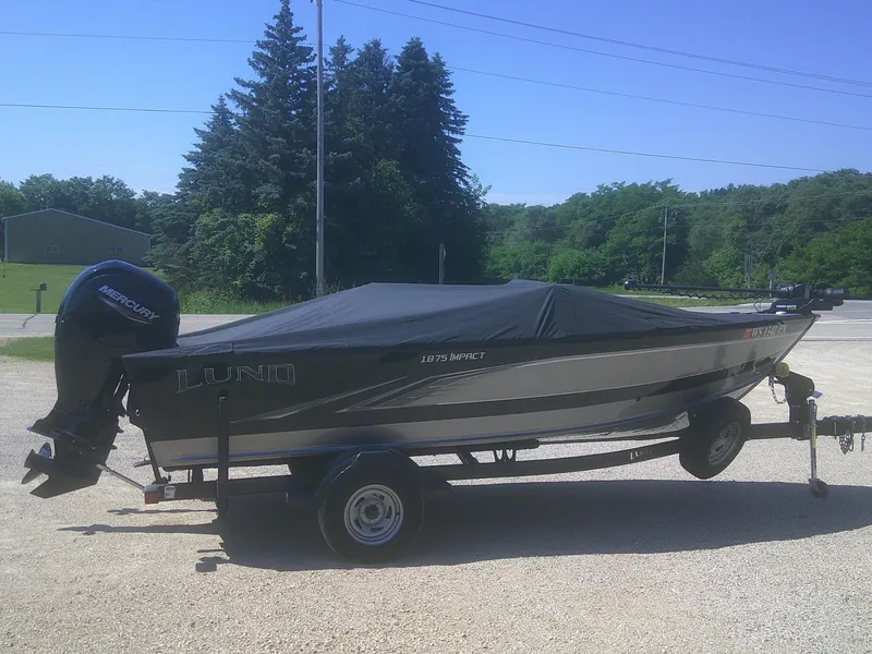 Slide: The Image of 2020 Lund 1875 Impact SS boat on trailer with cover, parked outdoors. - 18