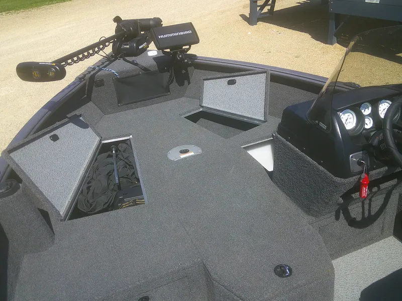 Slide: The Image of 2020 Lund 1875 Impact SS boat interior with storage compartments and Humminbird fish finder. - 5