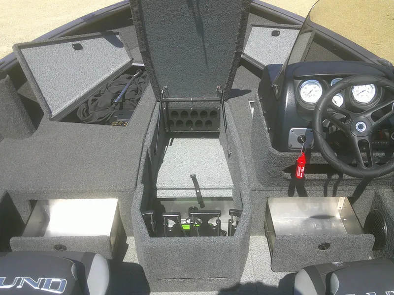 Slide: The Image of 2020 Lund 1875 Impact SS boat interior with storage compartments and steering console. - 6