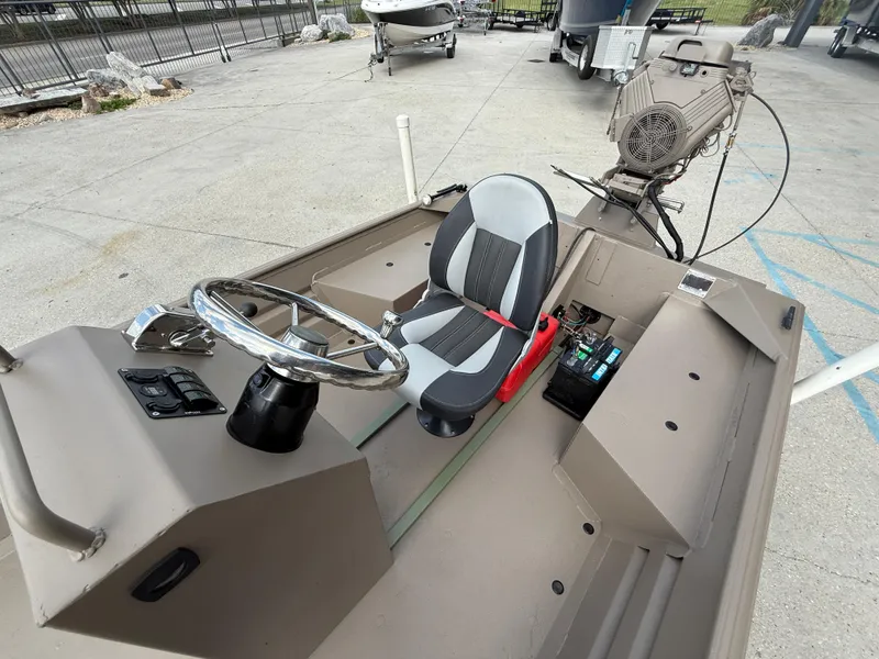 Slide: The Image of 2018 Alweld 1752 Marsh Series boat interior with steering wheel and seat. - 11