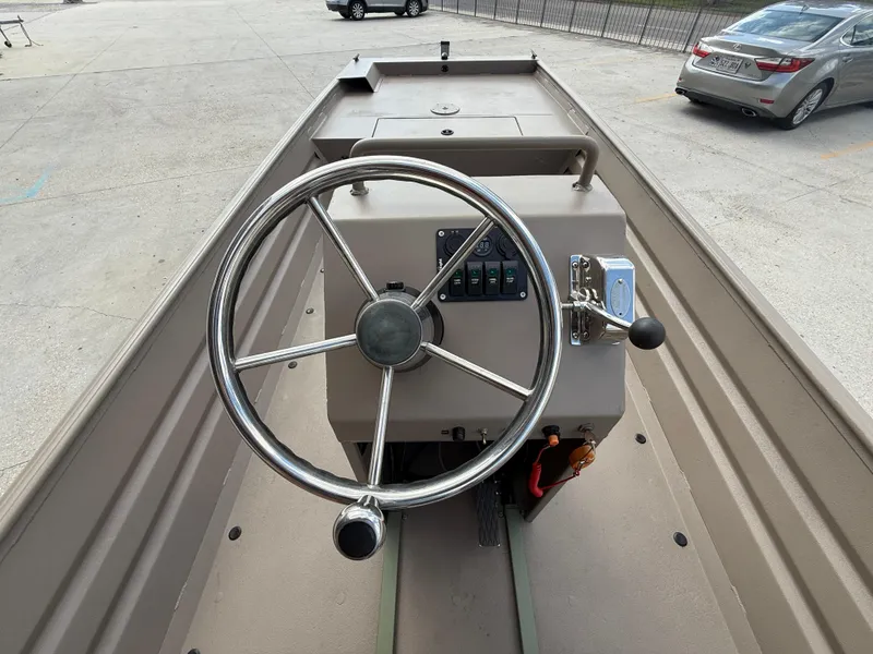 Slide: The Image of 2018 Alweld 1752 Marsh Series boat steering console with controls and steering wheel. - 12