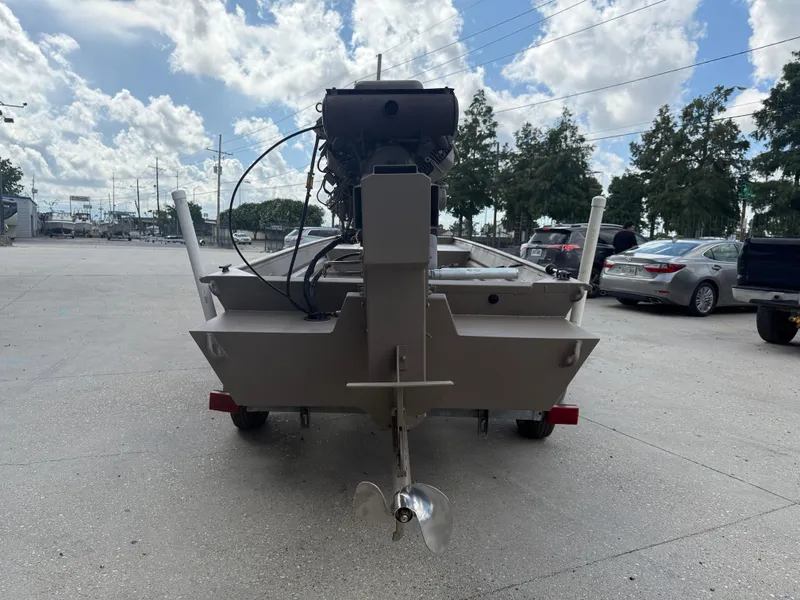 Slide: The Image of 2018 Alweld 1752 Marsh Series boat, rear view, parked outdoors under a cloudy sky. - 6