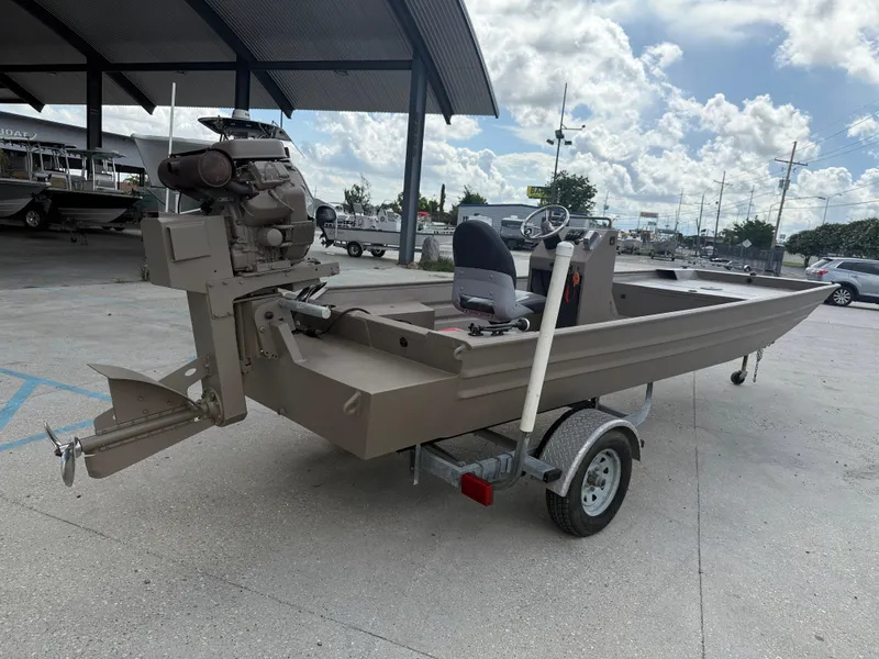 Slide: The Image of 2018 Alweld 1752 Marsh Series boat on trailer under a canopy, clear sky background. - 7