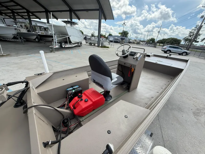 Slide: The Image of 2018 Alweld 1752 Marsh Series boat with steering console, parked under a canopy. - 8