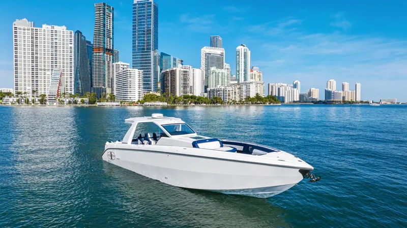 Slide: The Image of 2023 Cigarette 42 Auroris boat cruising near city skyline on a sunny day. - 2