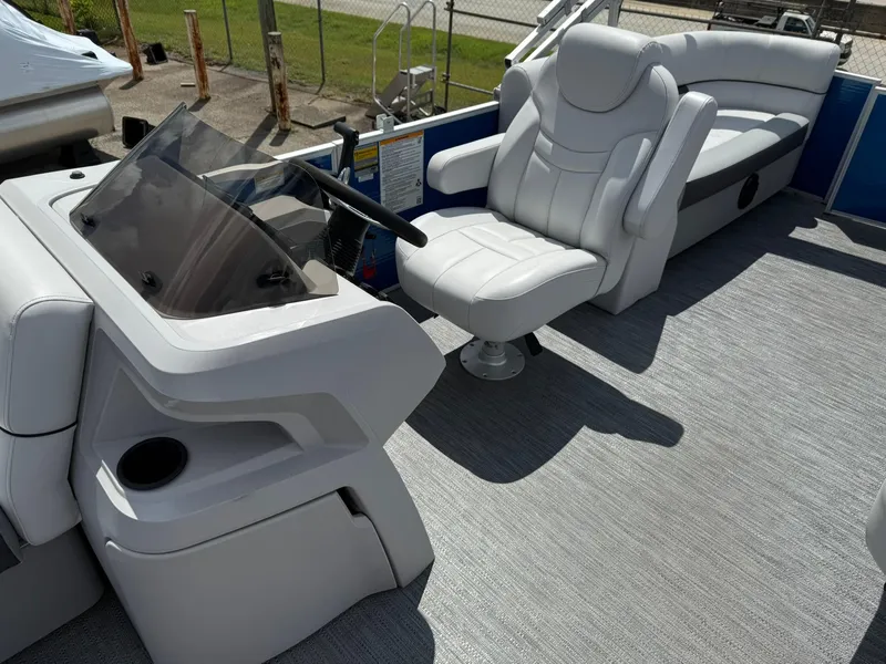 Slide: The Image of 2024 Godfrey SWEETWATER 2286 SB boat interior with captain's chair and dashboard. - 5