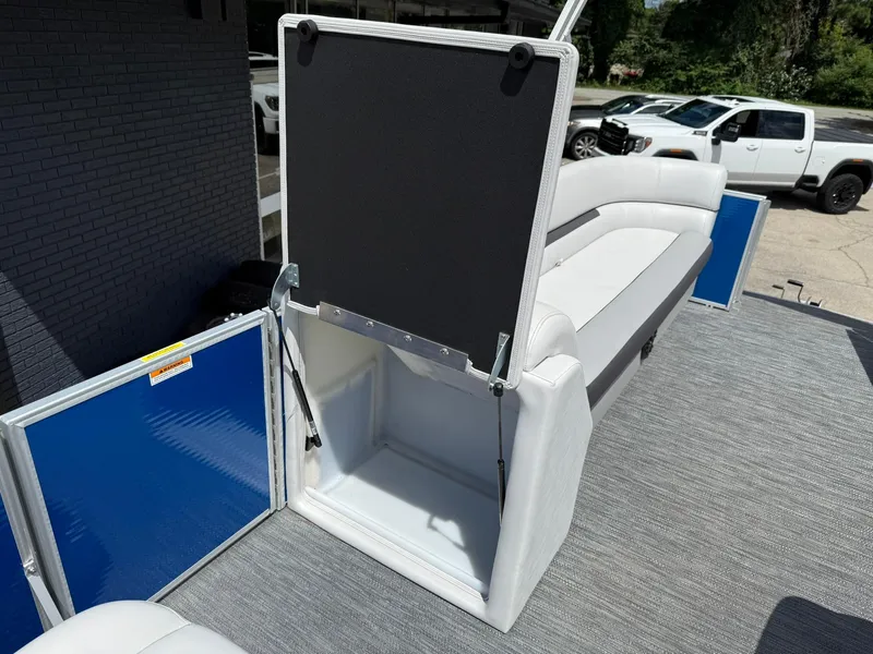 Slide: The Image of 2024 Godfrey SWEETWATER 2286 SB boat interior with open storage compartment and seating. - 7