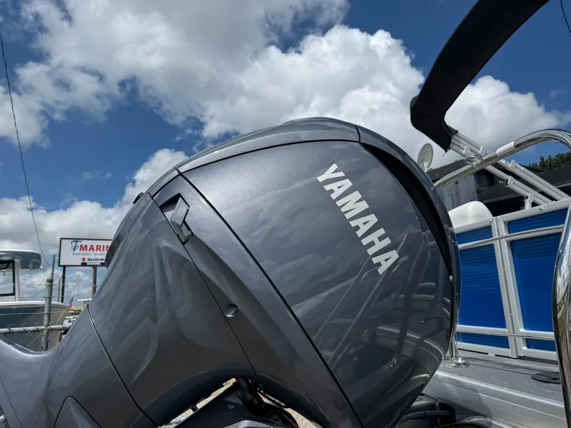 Slide: The Image of Yamaha outboard motor on 2024 Godfrey SWEETWATER 2286 SB pontoon boat under blue sky. - 9
