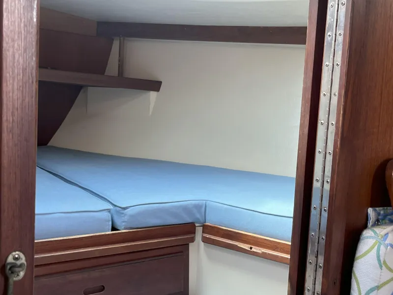 Slide: The Image of Interior cabin of 1989 Catalina 34 MkII sailboat with blue cushions and wooden finish. - 14