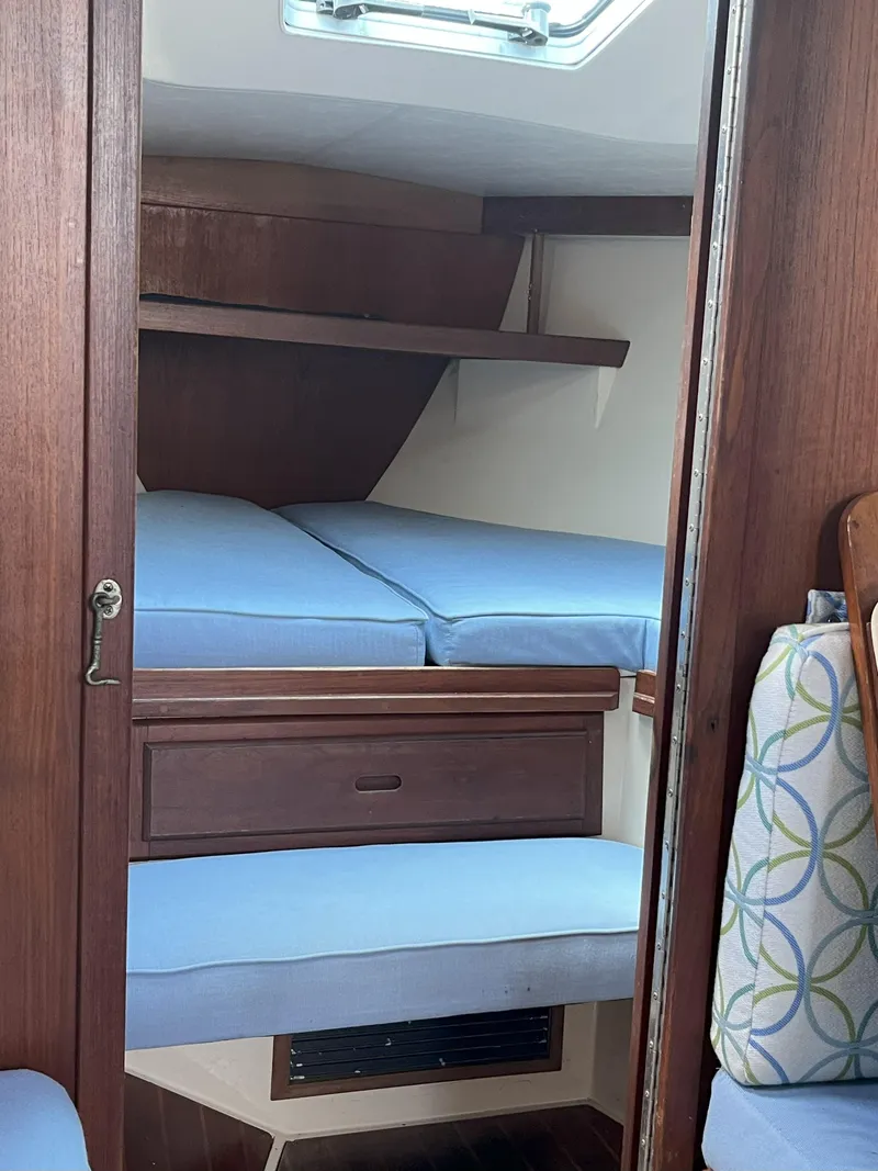 Slide: The Image of Interior cabin of a 1989 Catalina 34 MkII sailboat with blue cushions. - 15