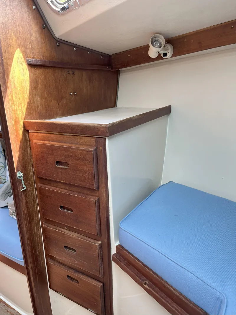 Slide: The Image of Interior of 1989 Catalina 34 MkII sailboat with wooden drawers and blue cushion. - 16