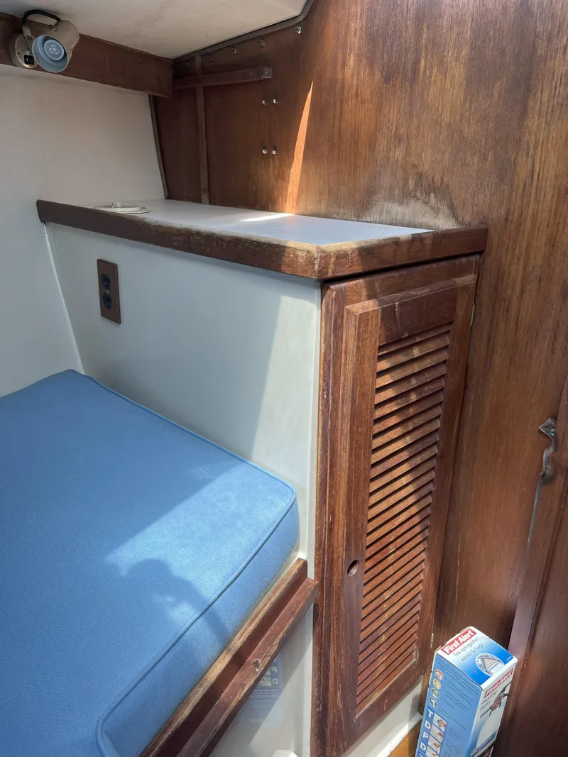 Slide: The Image of Interior of 1989 Catalina 34 MkII sailboat with blue cushion and wooden cabinetry. - 17