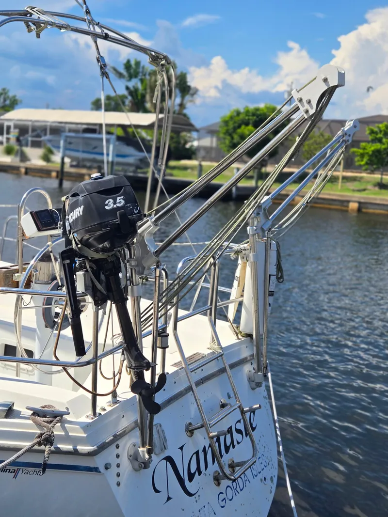 Slide: The Image of Catalina 34 MkII sailboat with Mercury 3.5 motor docked by the water. - 5