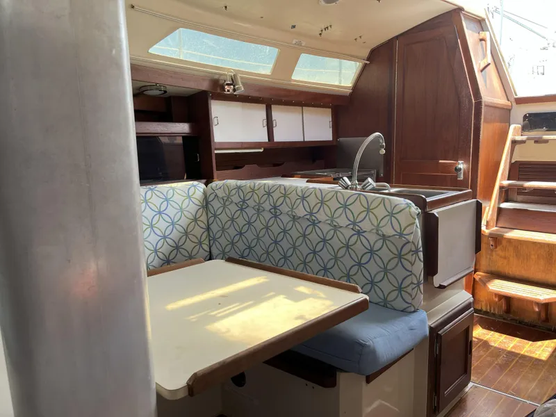 Slide: The Image of Interior of 1989 Catalina 34 MkII sailboat with dining area and wooden cabinetry. - 6