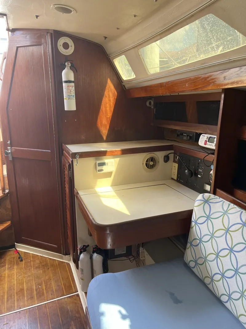 Slide: The Image of Interior of 1989 Catalina 34 MkII sailboat with navigation station and wooden cabinetry. - 9