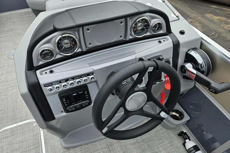 Slide: The Image of 2023 South Bay S224 UL TRIPLE boat dashboard with steering wheel and control panel. - 12