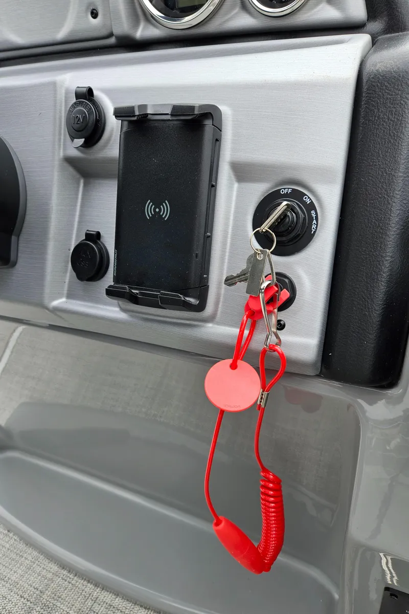 Slide: The Image of Dashboard of 2023 South Bay S224 UL TRIPLE with ignition keys and phone holder. - 14