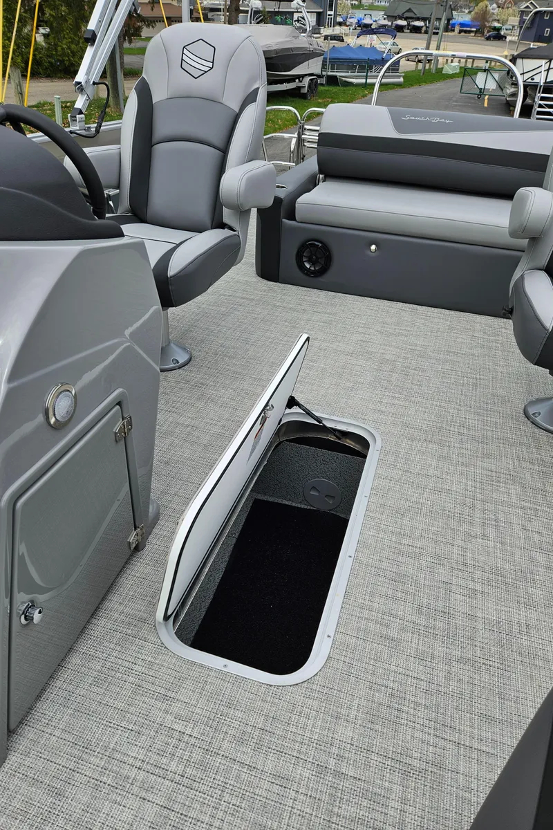 Slide: The Image of 2023 South Bay S224 UL TRIPLE pontoon boat interior with open storage compartment. - 21