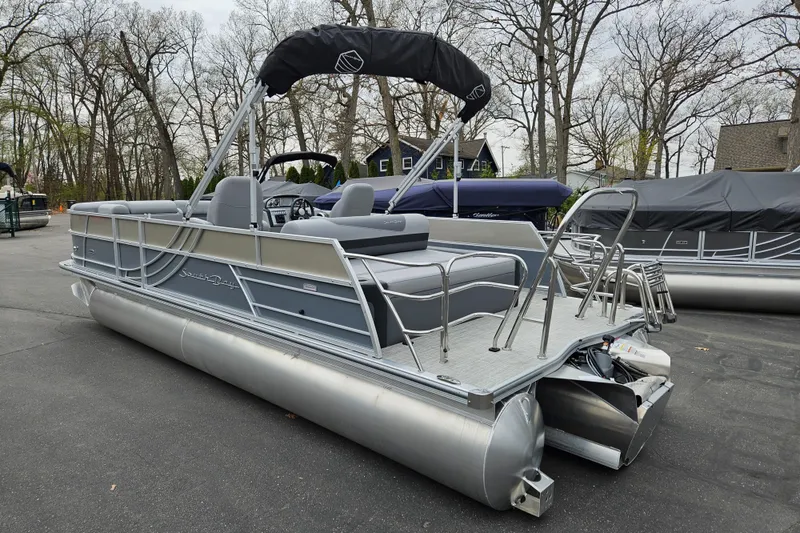 Slide: The Image of 2023 South Bay S224 UL TRIPLE pontoon boat with gray seating and canopy. - 3