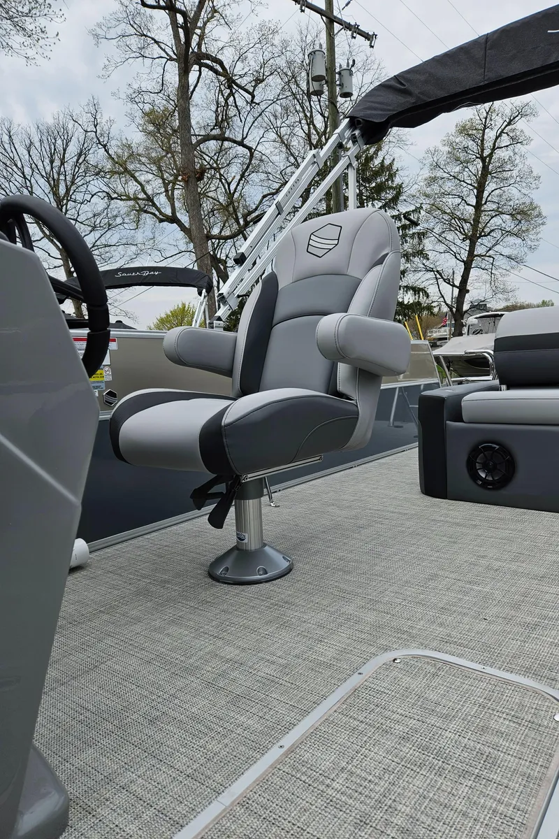 Slide: The Image of 2023 South Bay S224 UL TRIPLE boat interior with captain's chair and steering console. - 9