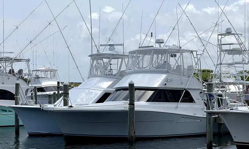 The Image of 1994 Viking 38 Convertible yacht docked at marina with fishing rods. - 0