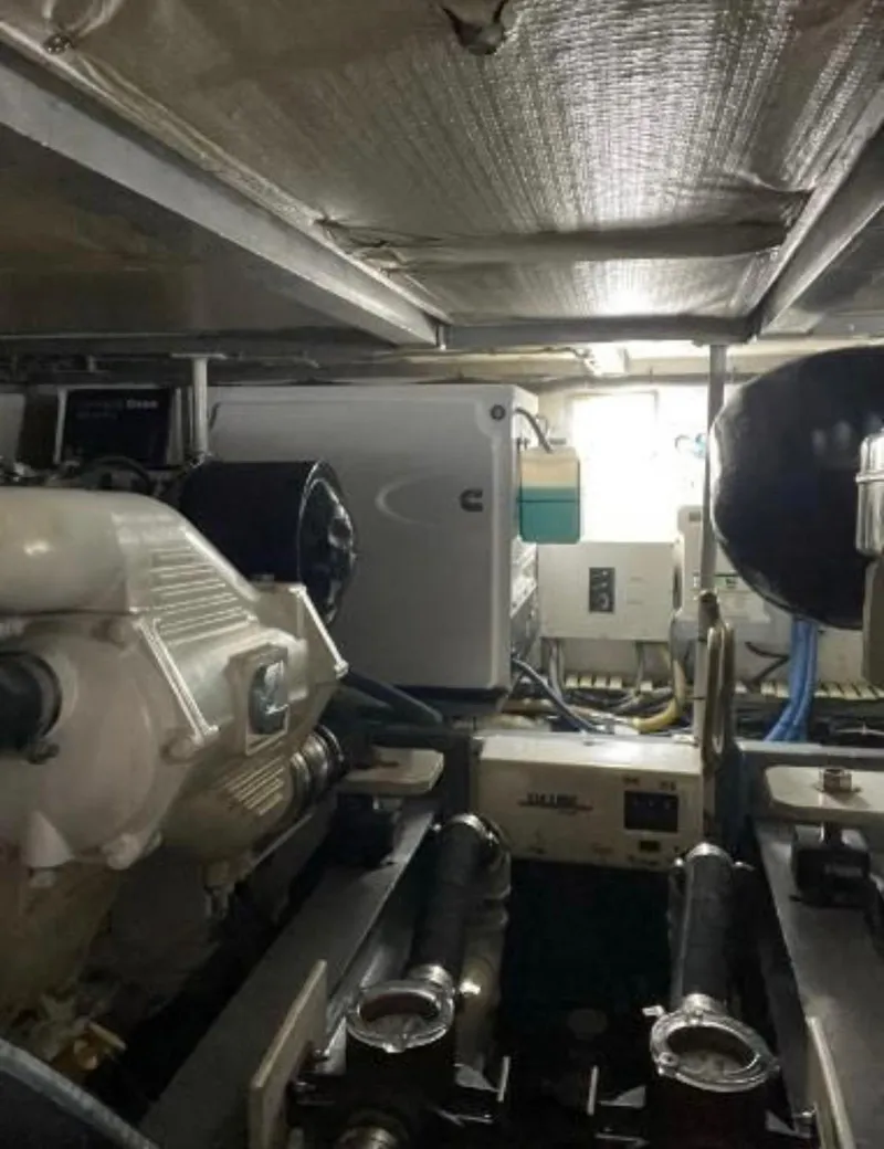 Slide: The Image of Engine room of a 1994 Viking 38 Convertible boat, showcasing machinery and equipment. - 5