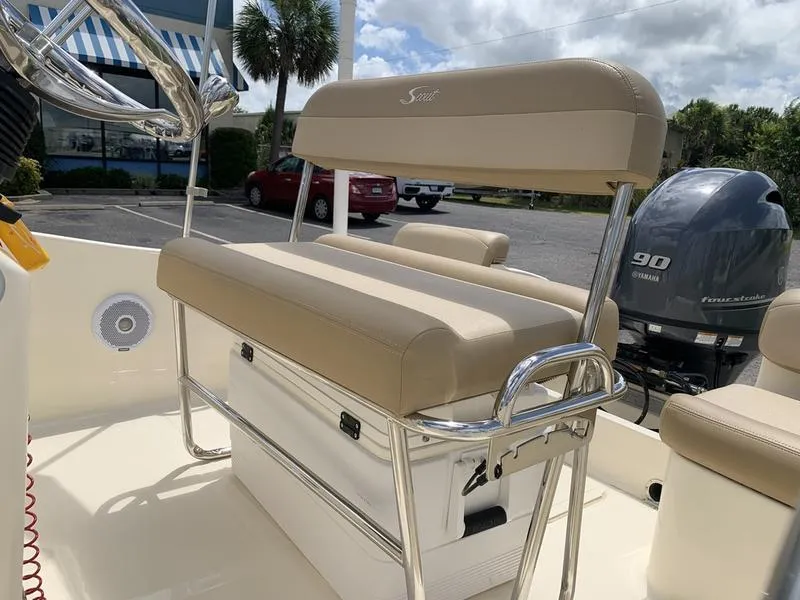 Slide: The Image of 2019 Scout 175 Sportfish boat interior with beige seating and Yamaha 90 outboard motor. - 10