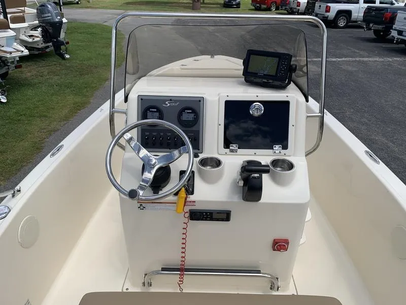 Slide: The Image of 2019 Scout 175 Sportfish boat console with steering wheel and navigation equipment. - 12