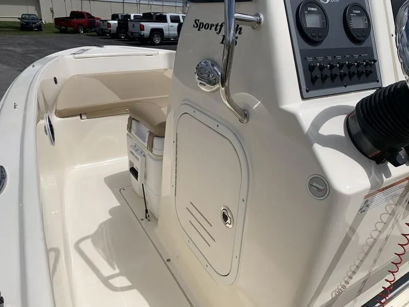 Slide: The Image of 2019 Scout 175 Sportfish boat interior with beige seating and control panel. - 17