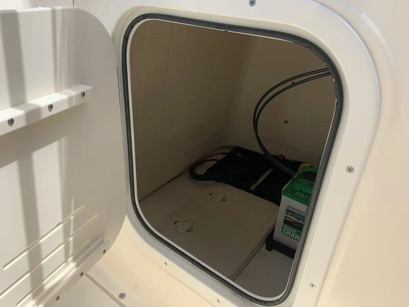 Slide: The Image of Storage compartment of 2019 Scout 175 Sportfish boat with battery and cables. - 18