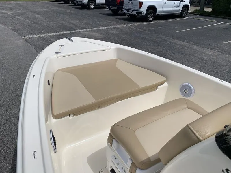 Slide: The Image of 2019 Scout 175 Sportfish boat interior with beige seating in a parking lot. - 19