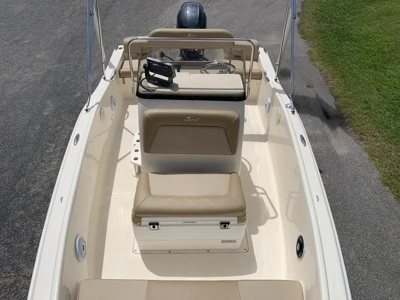Slide: The Image of 2019 Scout 175 Sportfish boat interior with beige seating and steering console. - 22