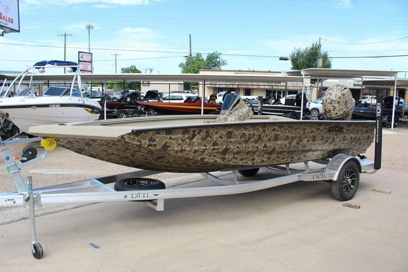 Slide: The Image of 2026 Excel Bolt 183 boat with camouflage design on a trailer in a dealership lot. - 12