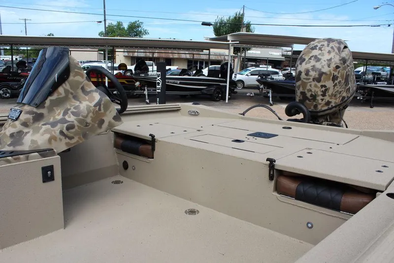 Slide: The Image of 2026 Excel Bolt 183 boat interior with camouflage accents, parked outdoors. - 13