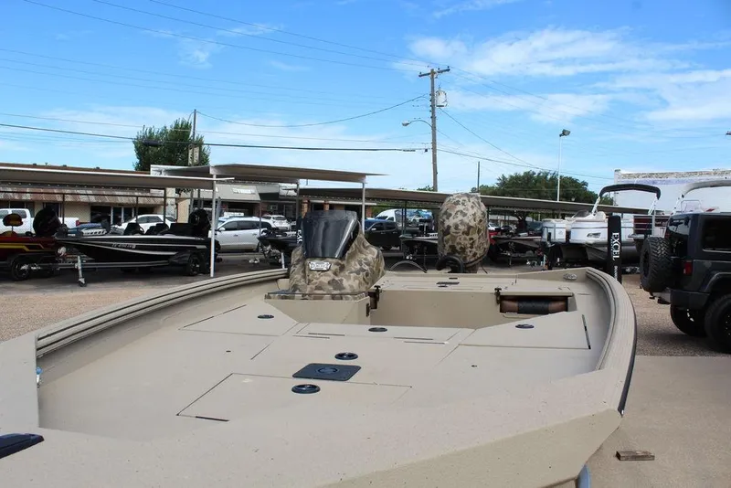 Slide: The Image of 2026 Excel Bolt 183 boat displayed in outdoor showroom with other vehicles. - 15