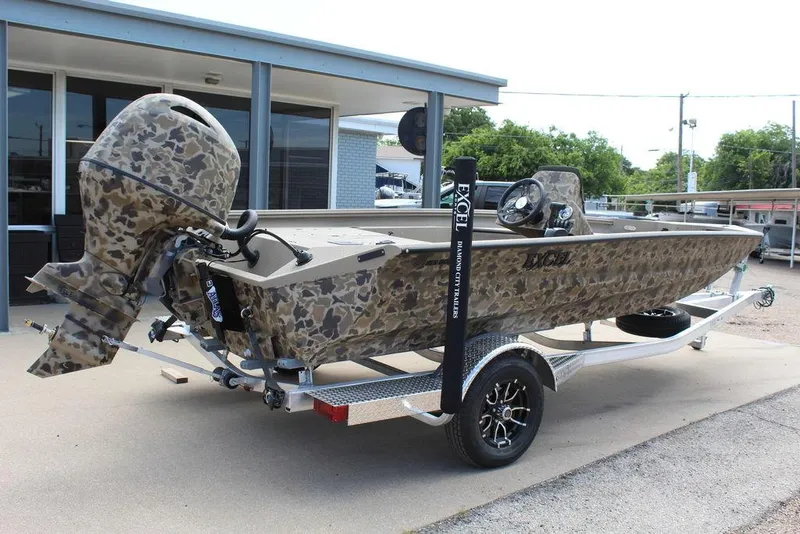 Slide: The Image of 2026 Excel Bolt 183 boat with camouflage design on a trailer, parked outdoors. - 3