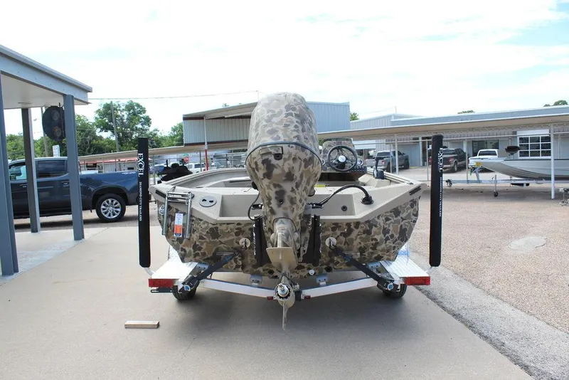 Slide: The Image of 2026 Excel Bolt 183 boat with camouflage design on a trailer in a dealership lot. - 5